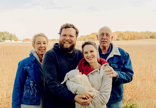 Image of Caption: Charles Pol with newborn daughter, wife, and parents